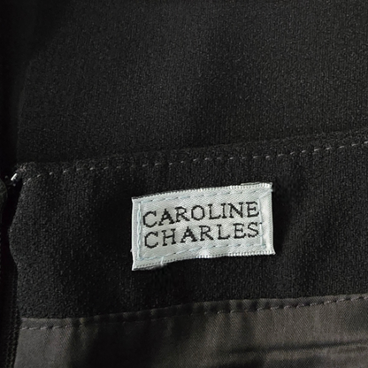 Black fabric with a 'Caroline Charles' label
