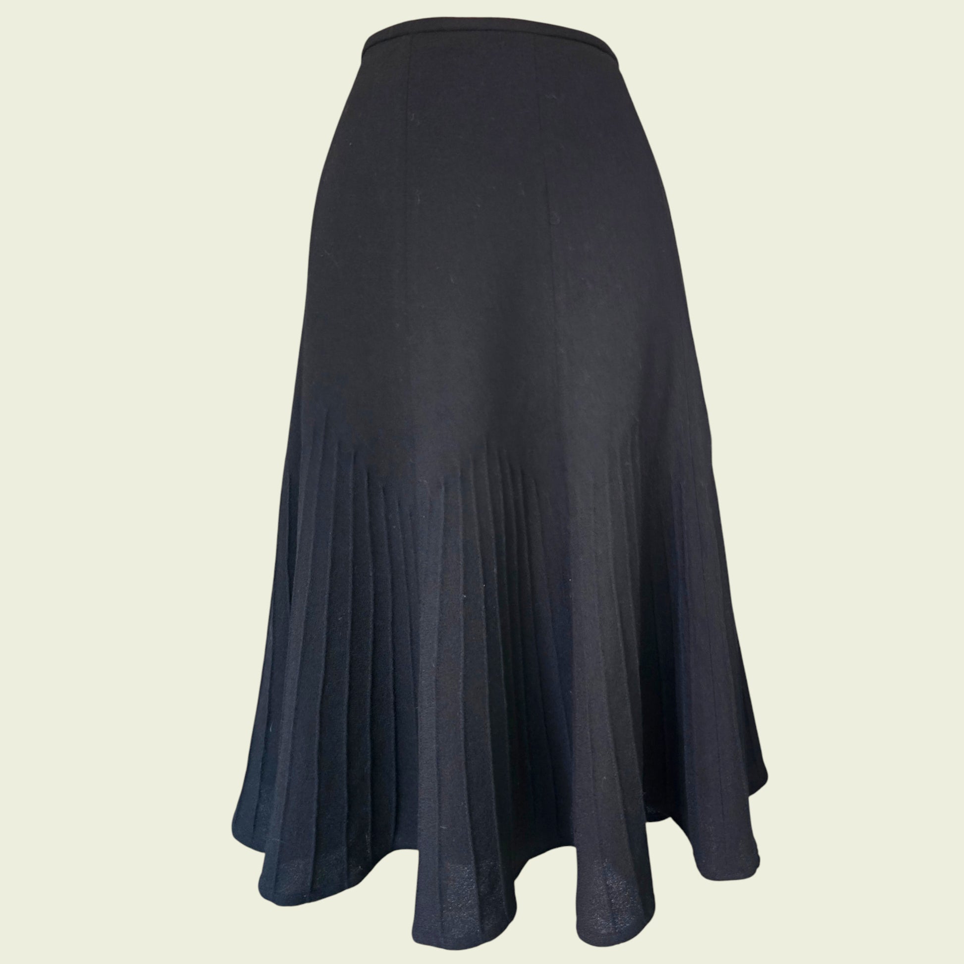 Black flared skirt on a beige background