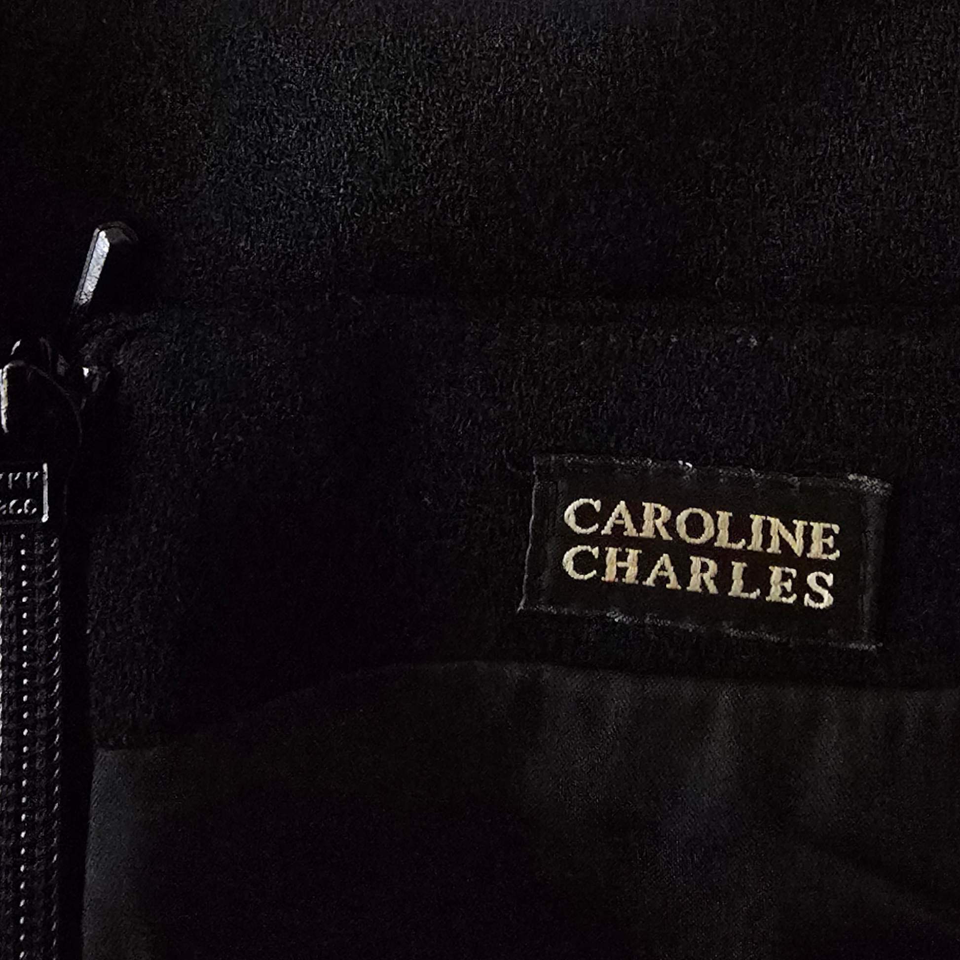 Black fabric with 'Caroline Charles' label