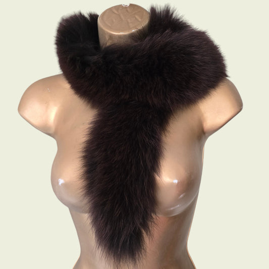 Mannequin wearing brown fur collar, stole on beige background
