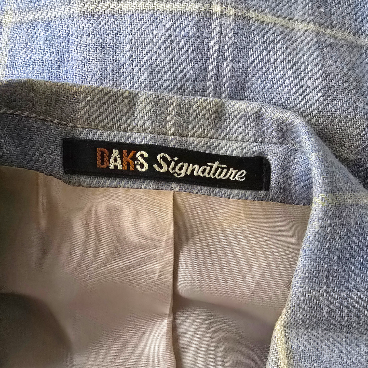 Close-up of a label on a piece of fabric with 'DAK'S Signature' text.