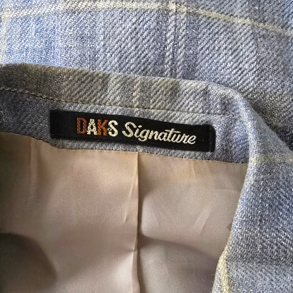 Close-up of a label on a piece of fabric with 'DAK'S Signature' text.