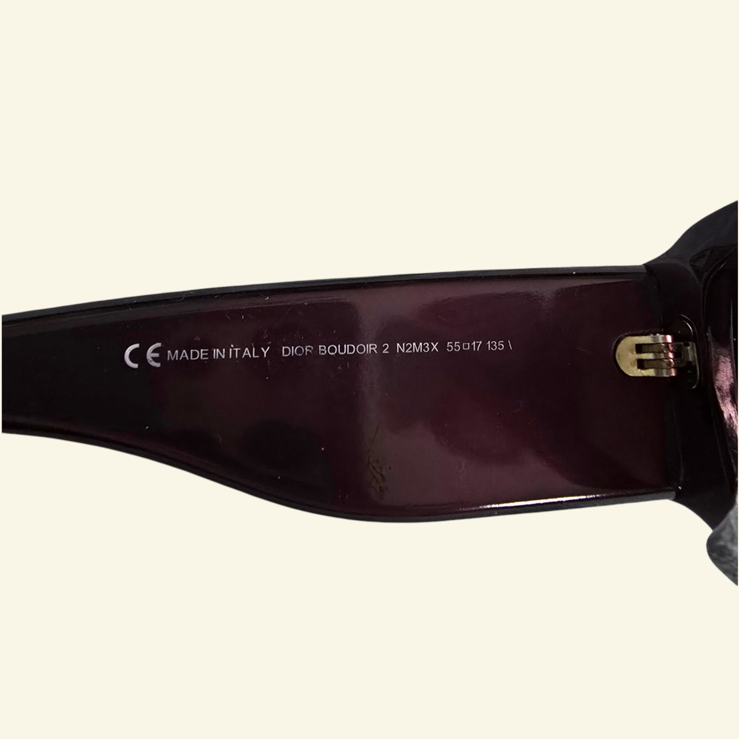 Mauve sunglasses with 'made in Italy' and Dior Boudoir on a white background