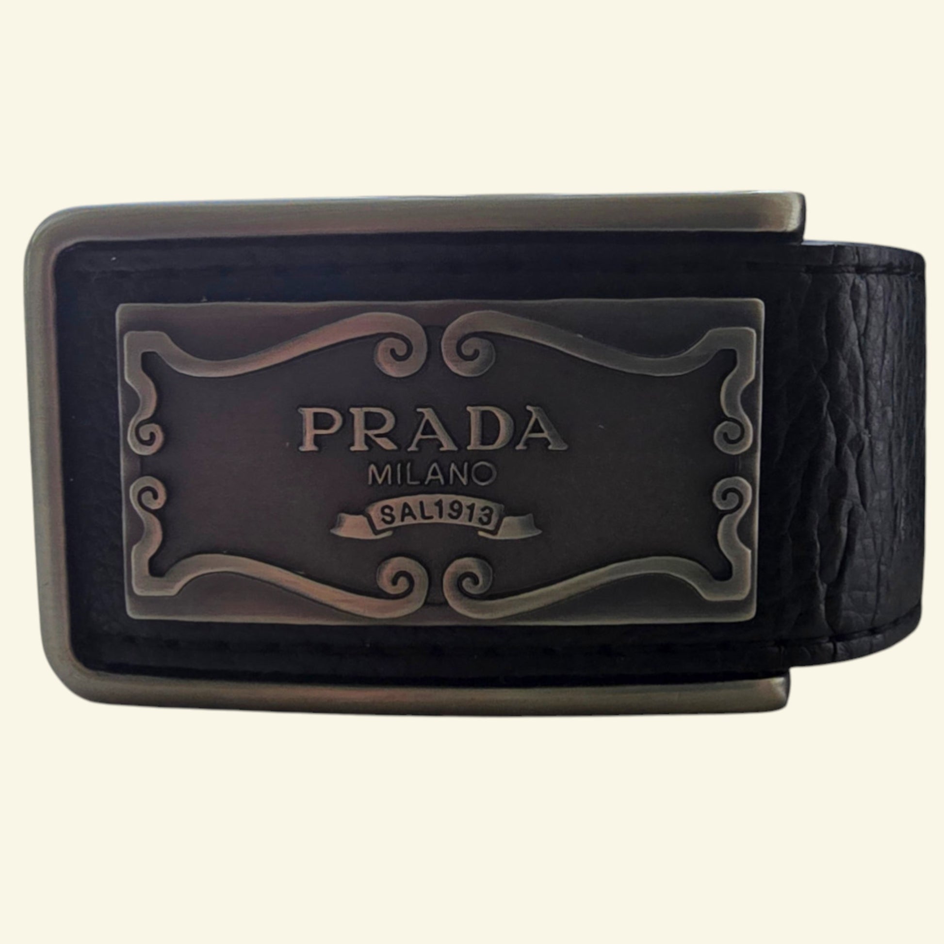 Black Prada belt with logo buckle on a beige background