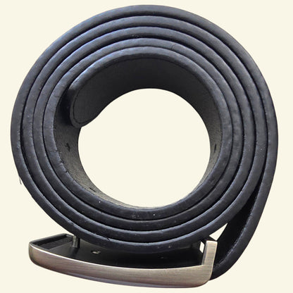 Coiled black leather belt on a beige background
