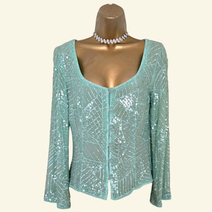 Light blue sequin top on a mannequin with a white background