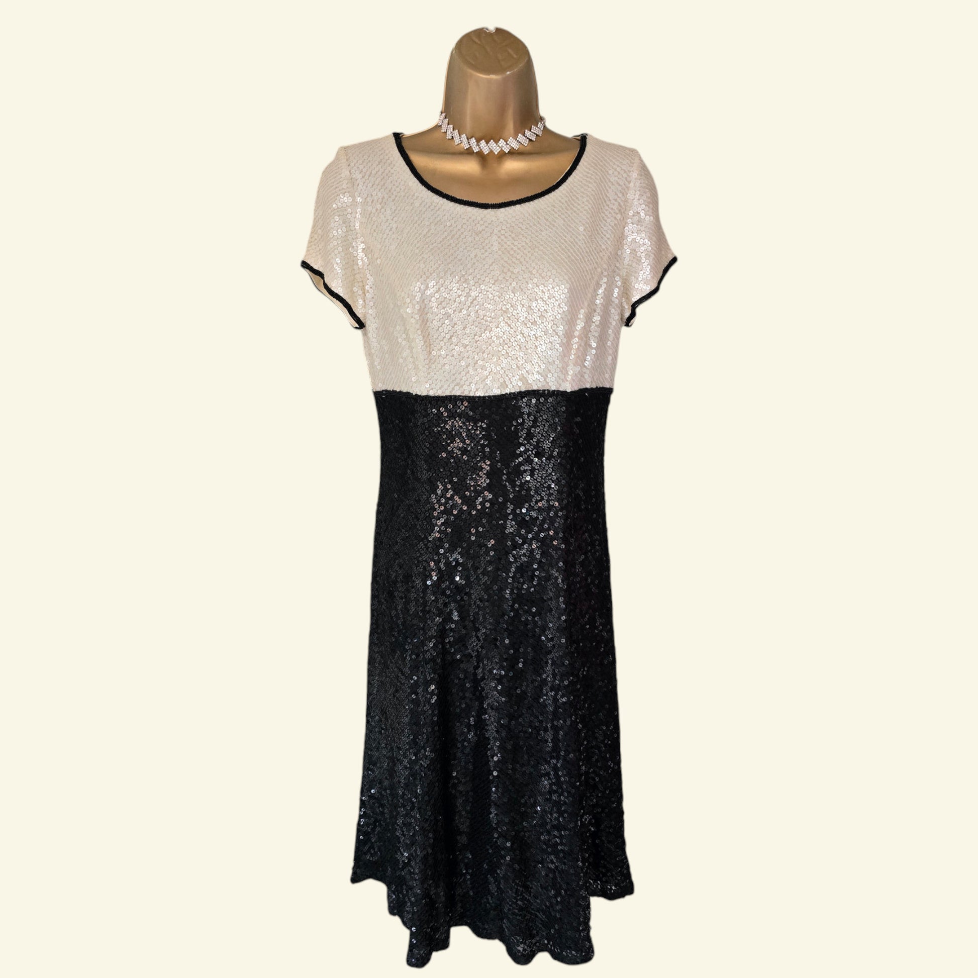 Two-tone sequin dress on a mannequin with a white background