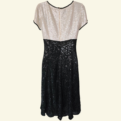 Two-tone sequin dress with white top and black bottom on a white background