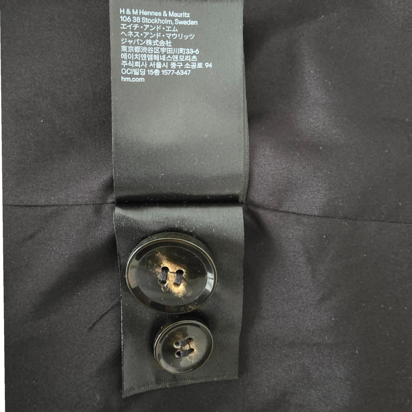 Close-up of buttons and a visible label on a dark background