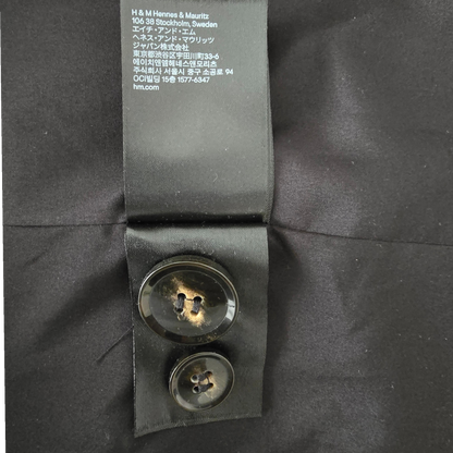 Close-up of buttons and a visible label on a dark background
