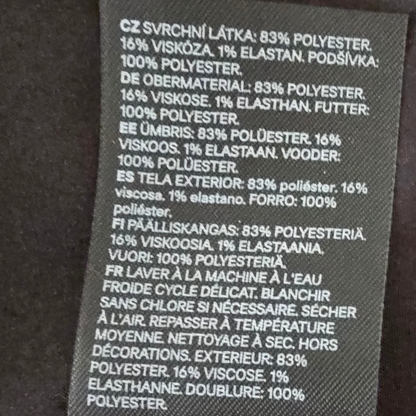 Textile label with material composition details on a dark background