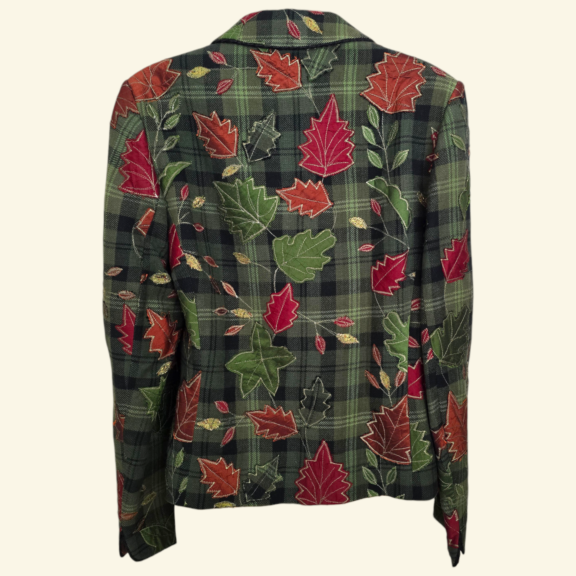 A long-sleeve plaid blazer jacket featuring an all-over autumn leaf pattern in red, green, and gold on a dark green plaid background, shown against a light cream background.