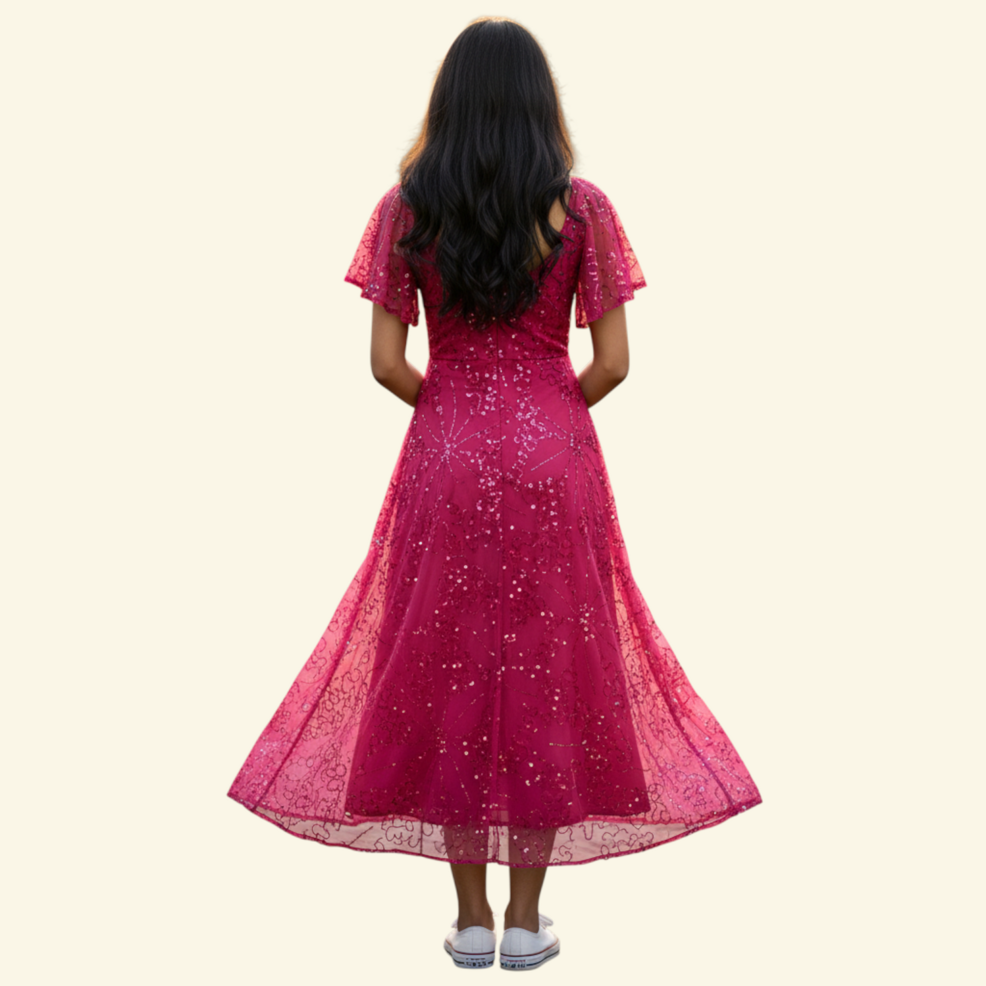 A woman viewed from behind wearing a bright pink sequined midi dress with short flutter sleeves and a flared skirt, standing against a plain light beige background.
