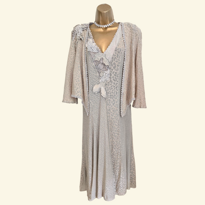 A light beige  patterned two-piece women's dress set, displayed on a gold mannequin against a cream background.
