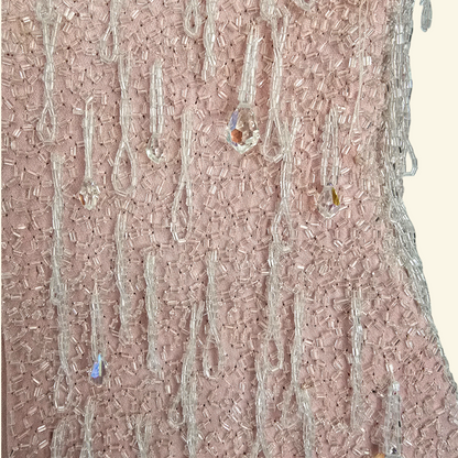 Close up of hand sewn bead detail on beige background