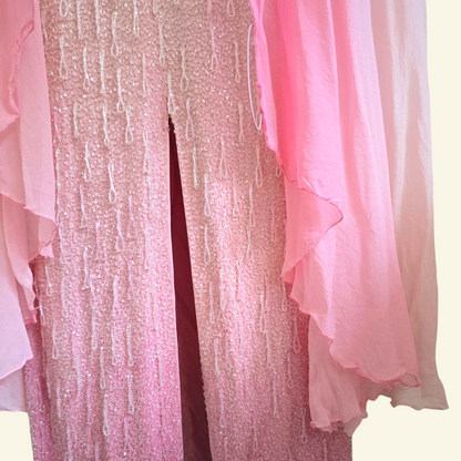 Close up of sheer fabric cape detailing thumb ring on beige background
