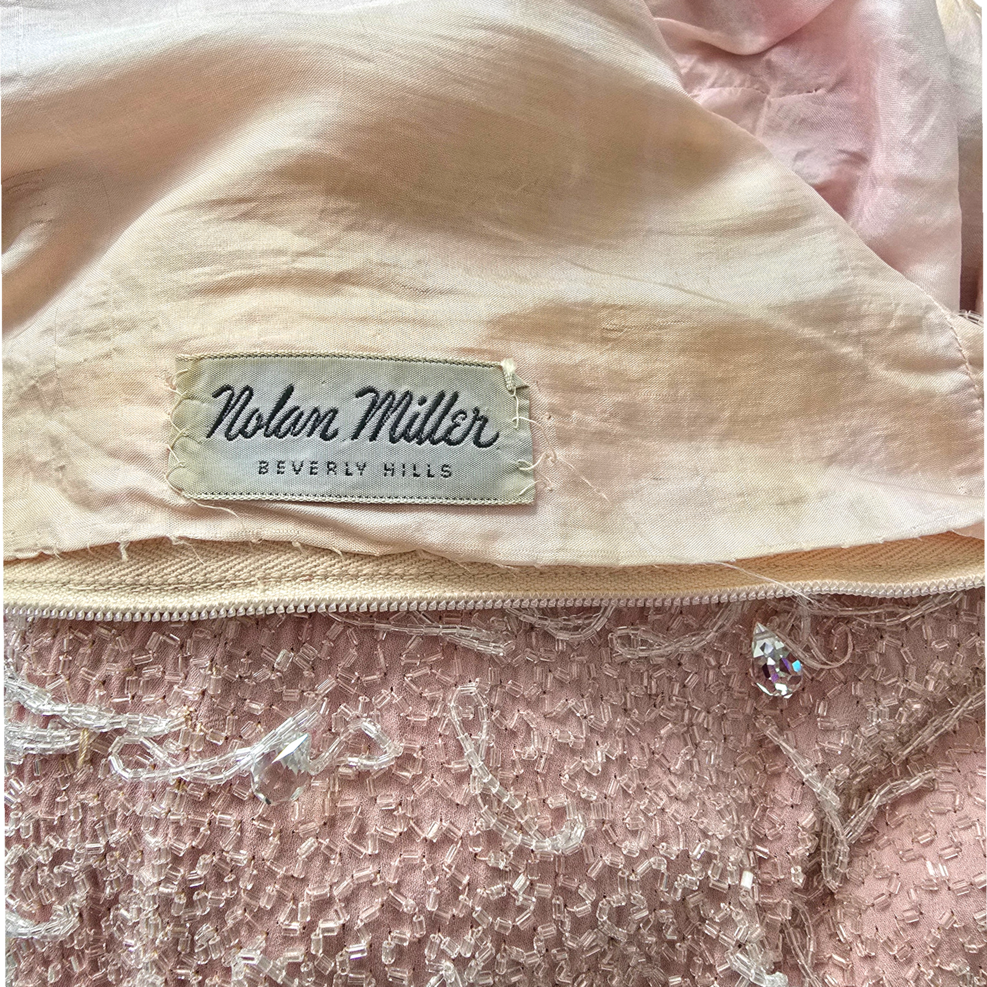 Nolan Miller Beverly Hills label on peach background