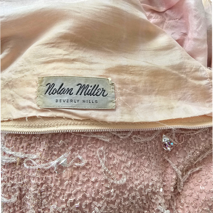 Nolan Miller Beverly Hills label on peach background
