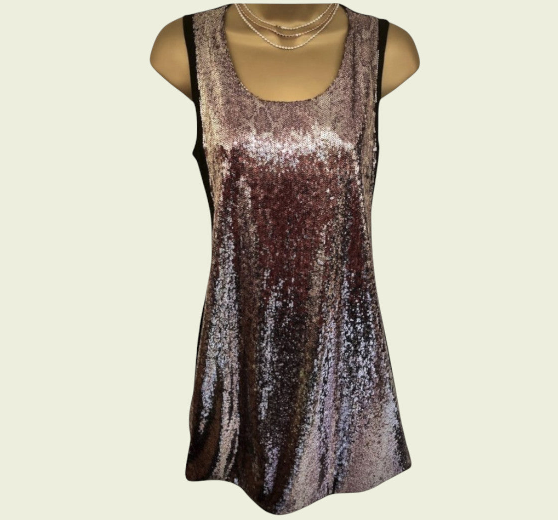 Sparkly sleeveless dress on a mannequin against a beige background
