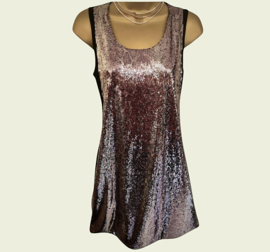 Sparkly sleeveless dress on a mannequin against a beige background