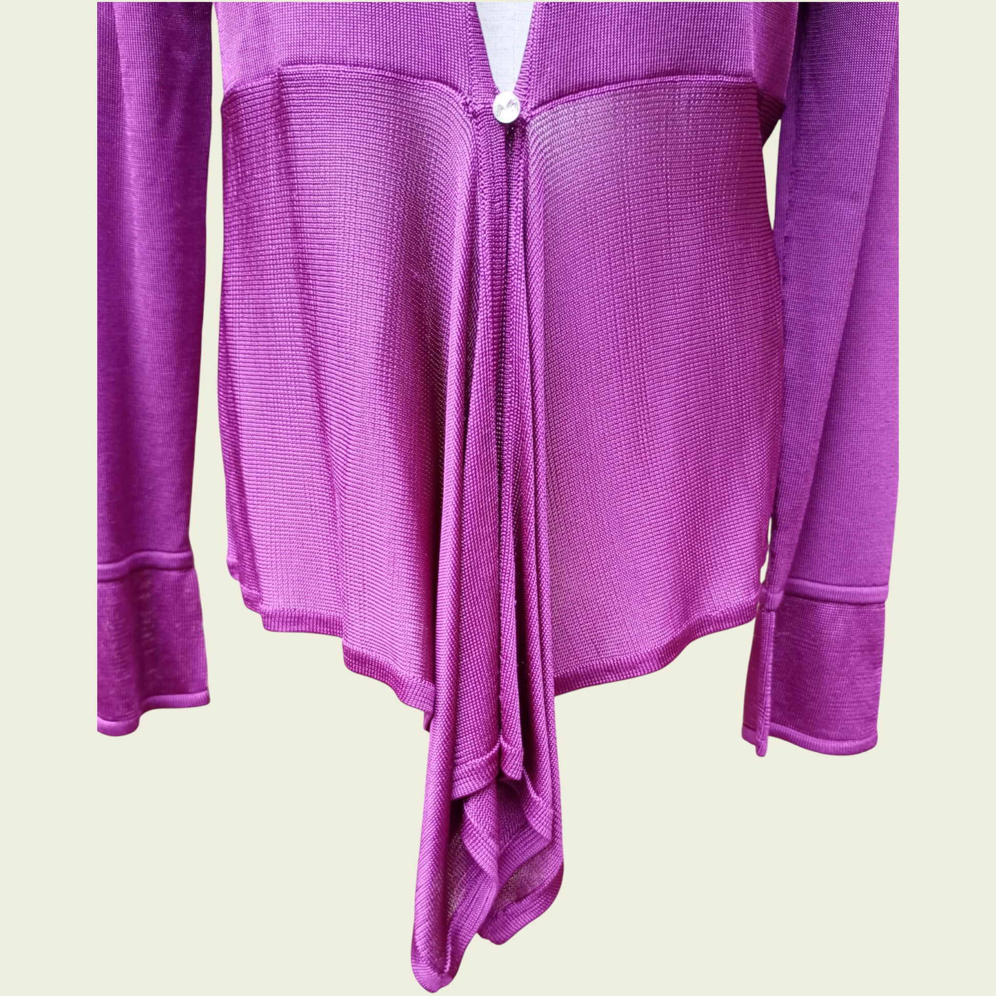 Fuchsia cardigan on a beige background