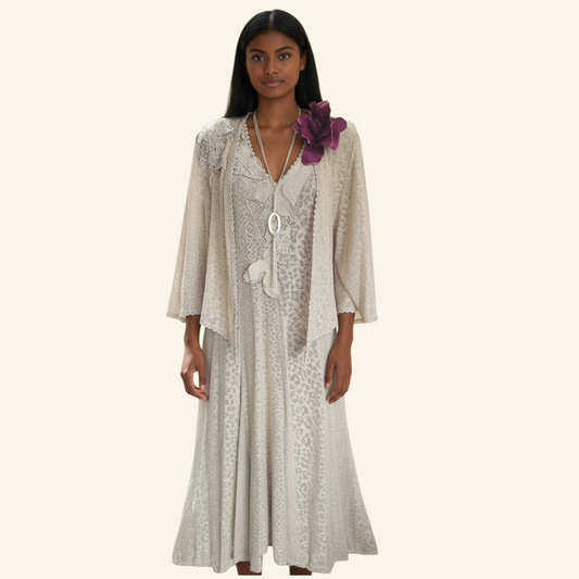 Model wearing a beige dress and jacket featuring lace detail on a white background