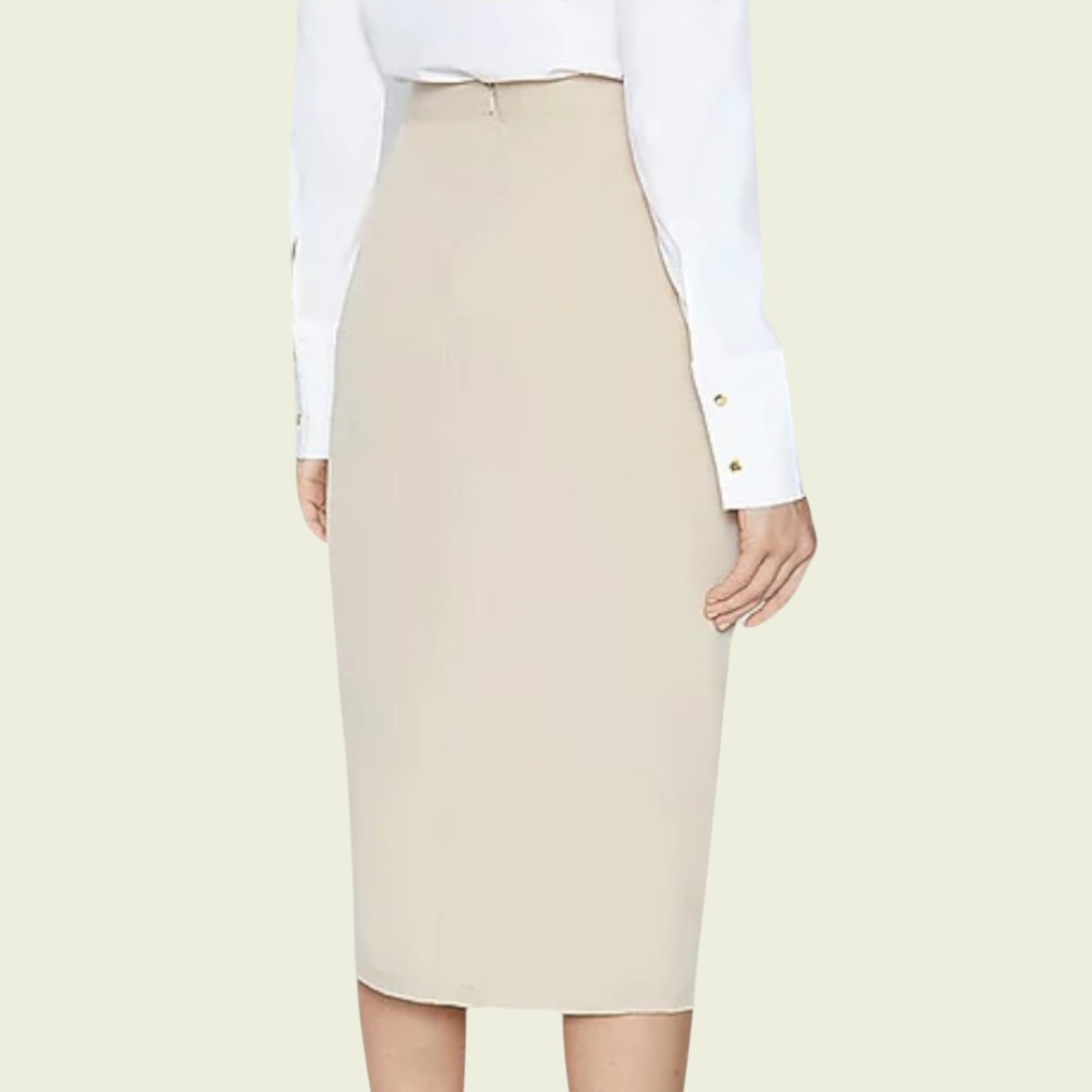 Beige pencil skirt worn with a white shirt on a light beige background