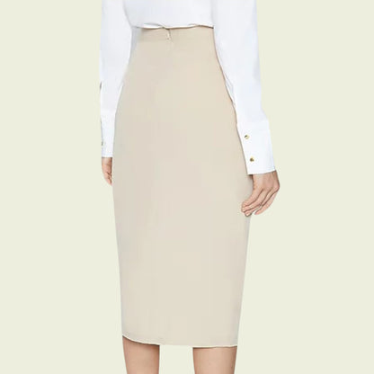 Beige pencil skirt worn with a white shirt on a light beige background