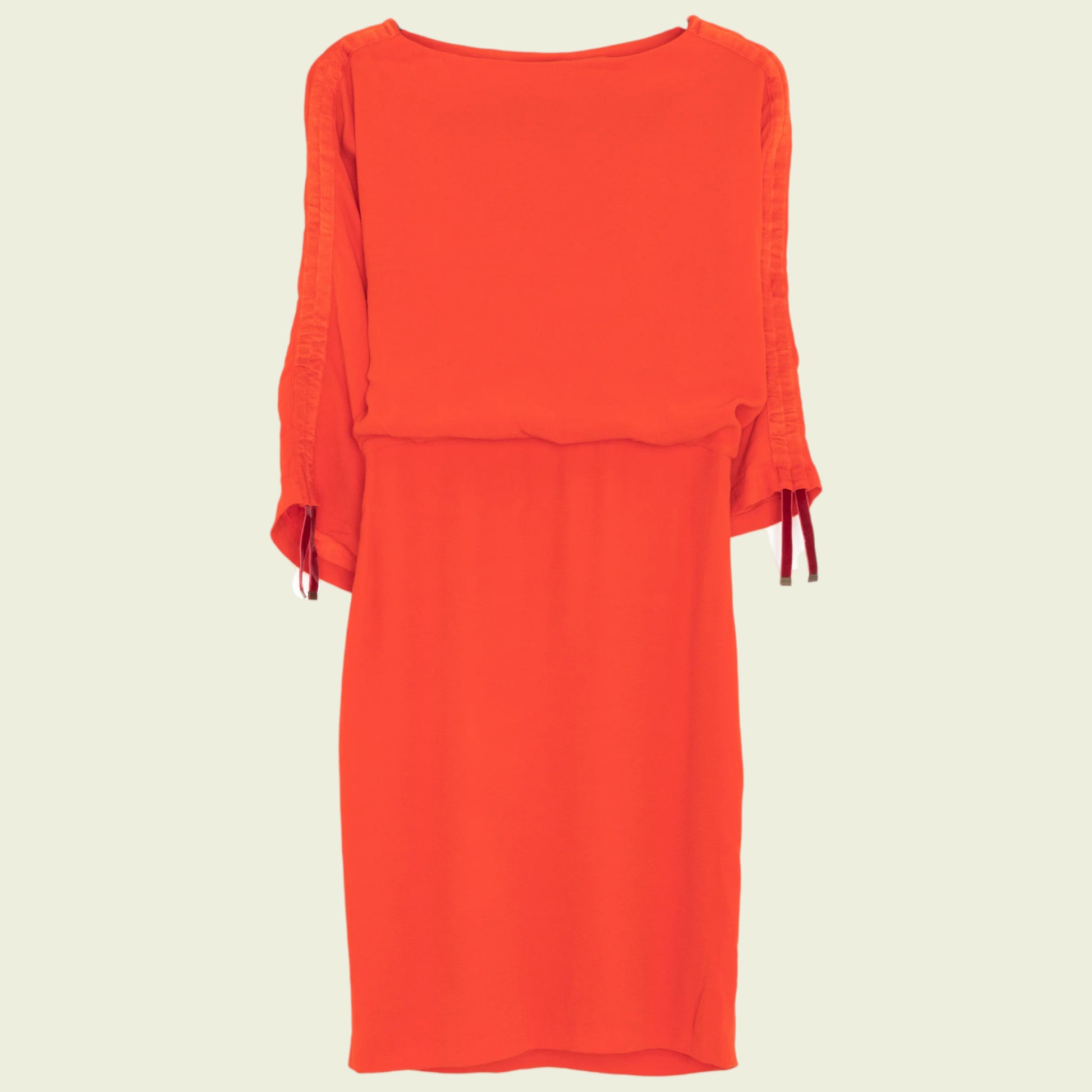 Red dress with ruffled sleeves on a beige background