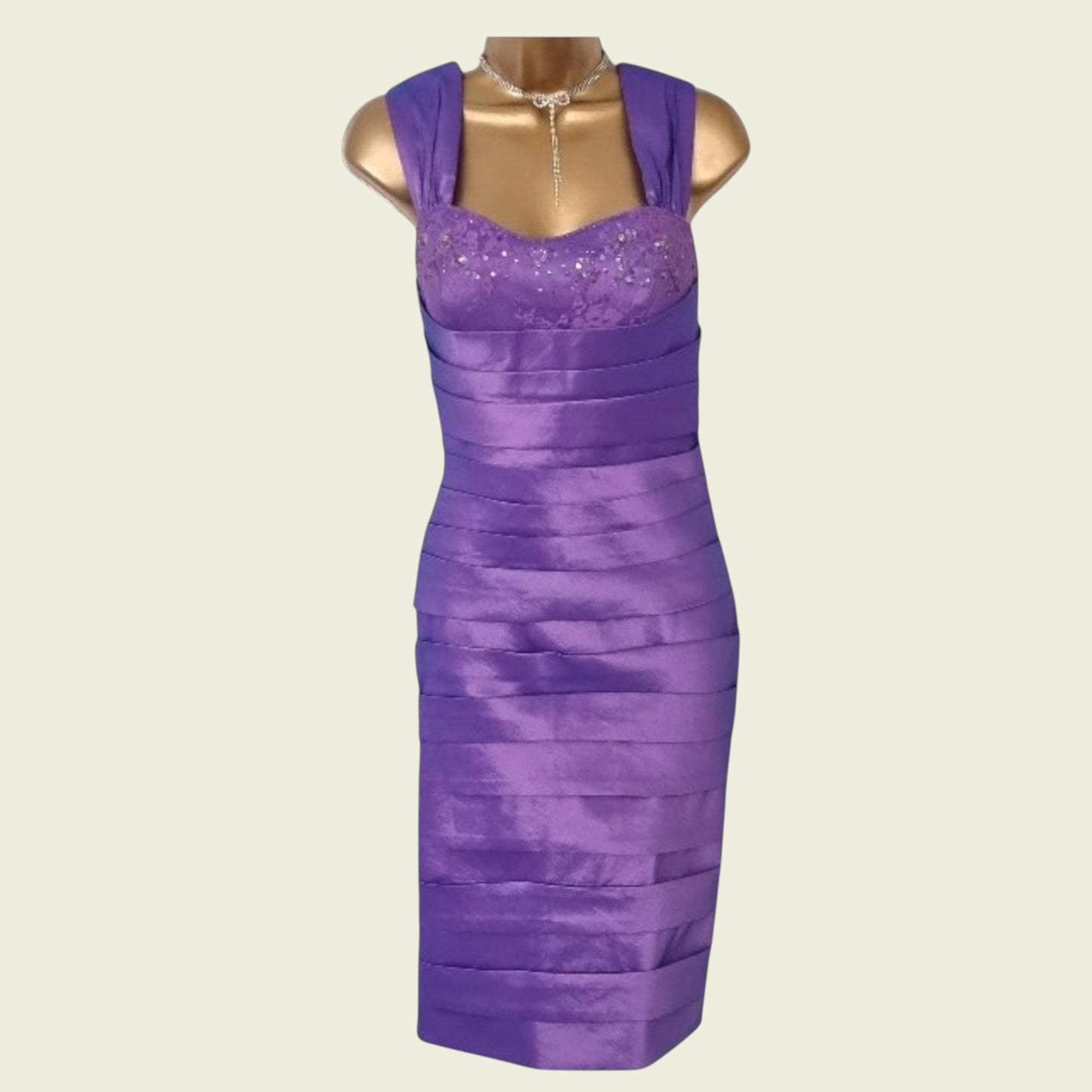 Purple dress on a mannequin against a beige background
