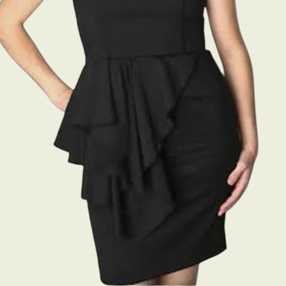 Black dress with ruffled details on a beige background