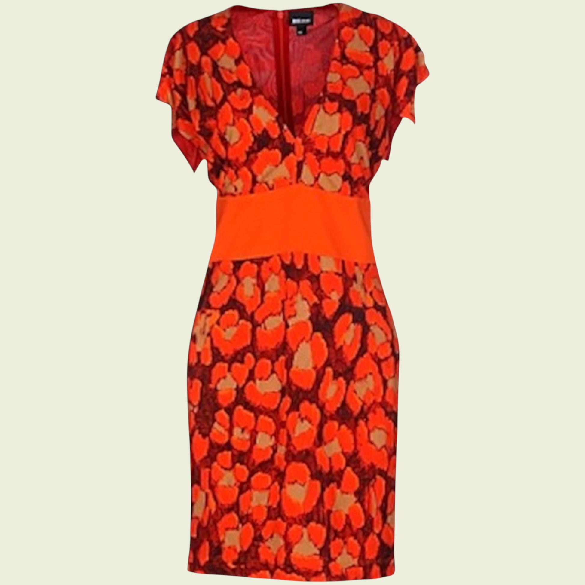 Mannequin wearing bright orange and black dress on beige background