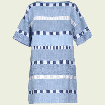 Blue and white patterned dress on a light beige background