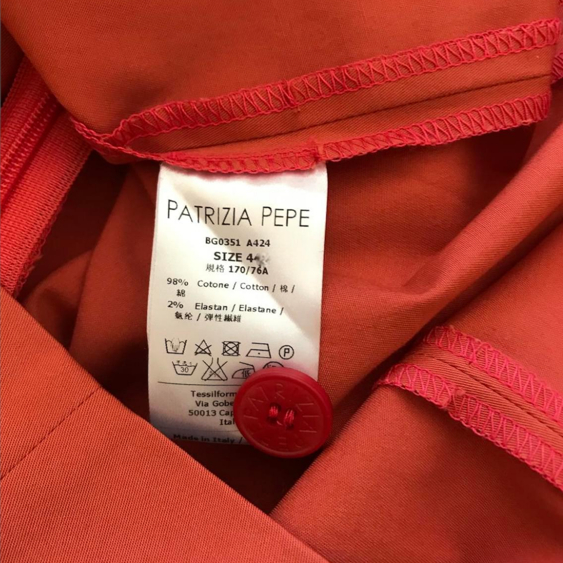 Patrizia Pepe label on a red garment with visible text and symbols.