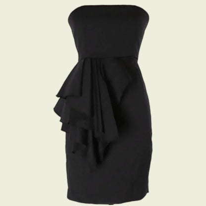 Black strapless dress with ruffled layers on a beige background