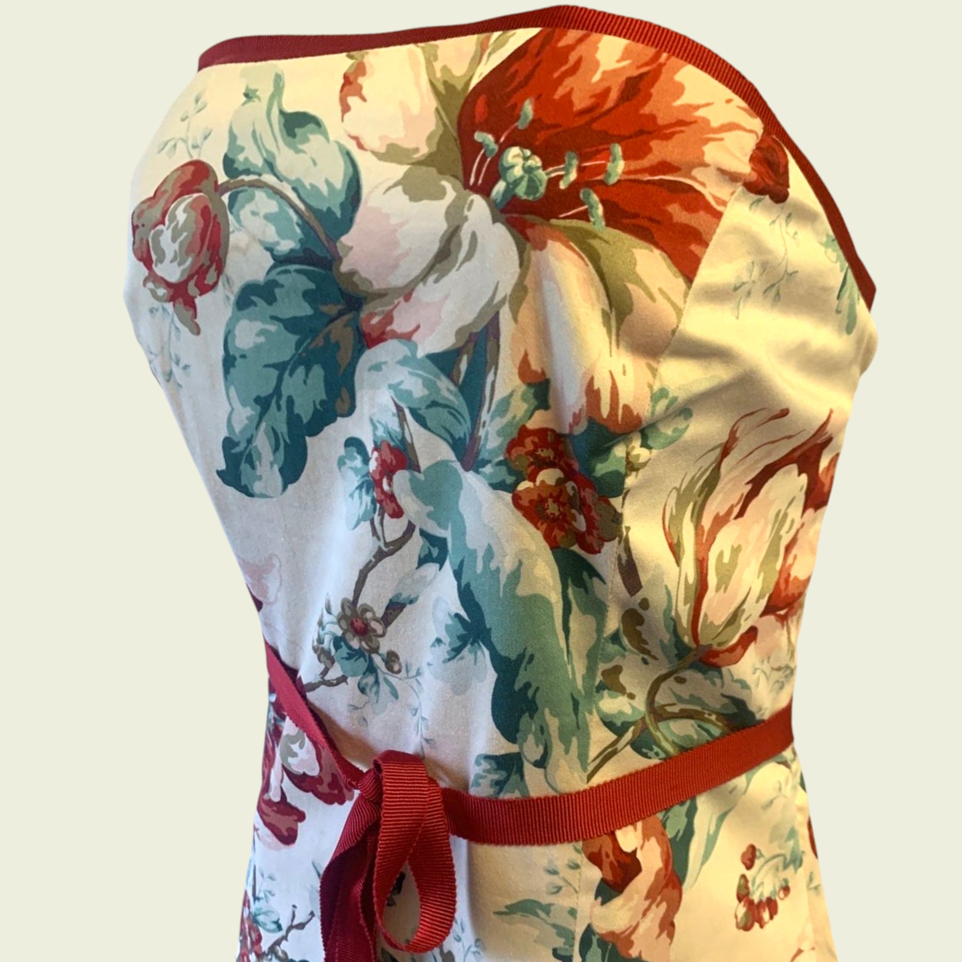 Floral-patterned dress with a red ribbon on a light background