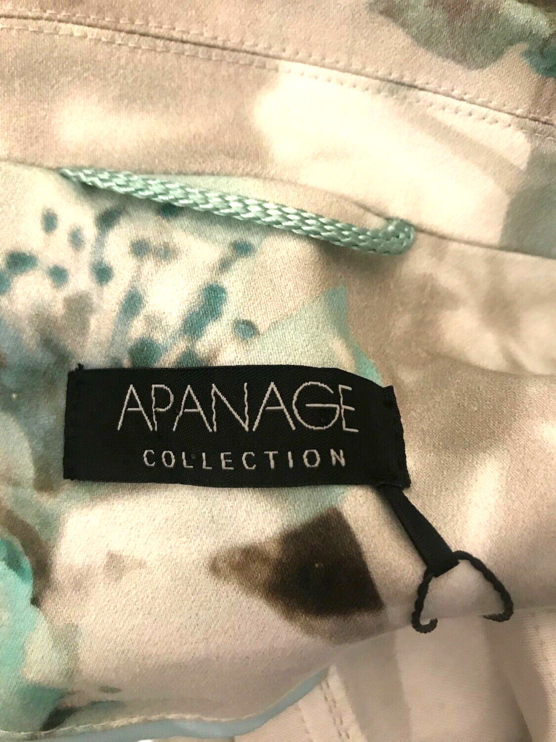 Clothing with 'APANAGE COLLECTION' label on a floral patterned fabric