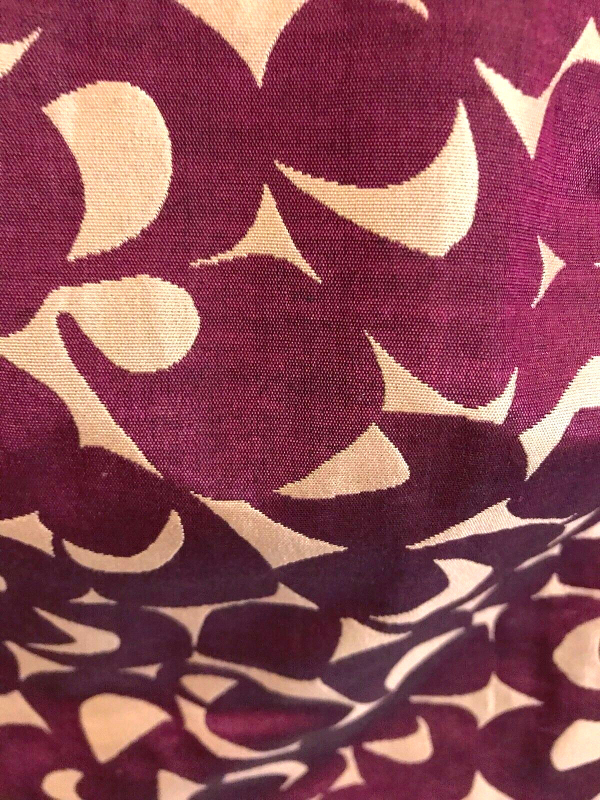 Close-up of fabric with purple and beige abstract pattern