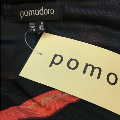 Clothing tag with 'pomodoro' brand name on a black fabric background