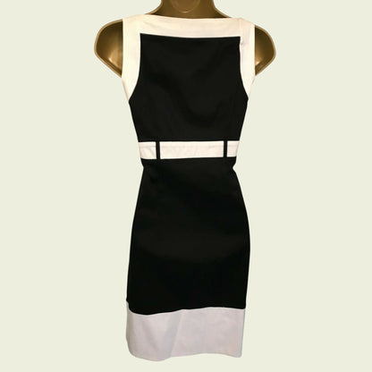 Mannequin wearing black and white dress on beige background