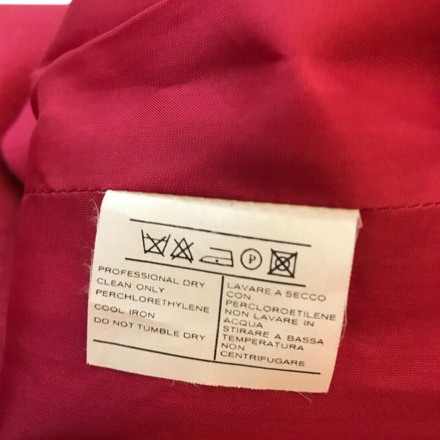 Clothing label on a red fabric background