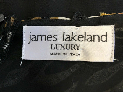 Label with 'james lakeland Luxury Made in Italy' on a dark fabric background