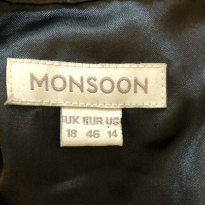 Monsoon label on a dark fabric background