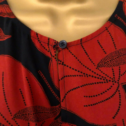 Red and black patterned fabric with a button on a mannequin