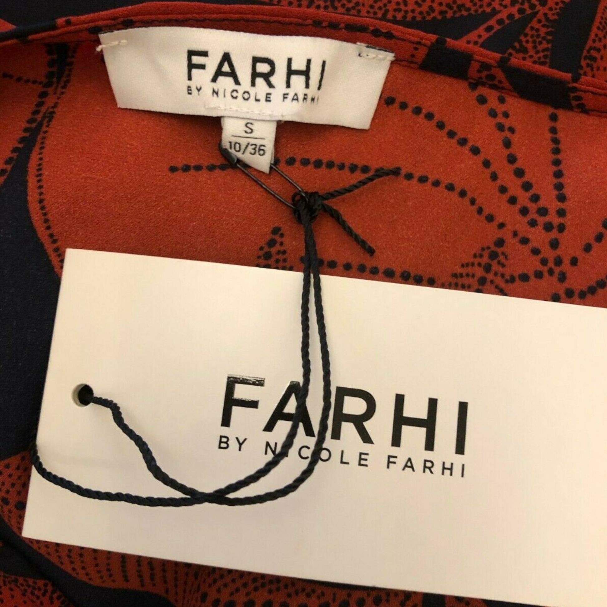 Clothing label Farhi on a red background