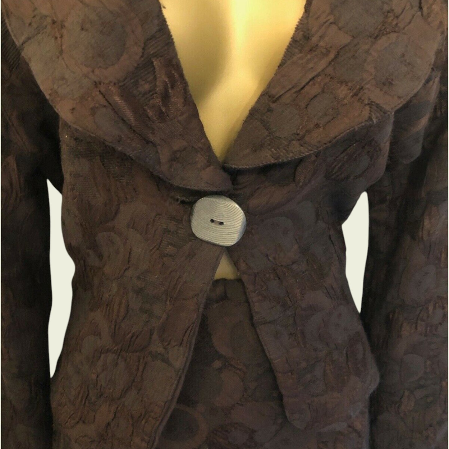 Brown textured coat on a mannequin with a plain background