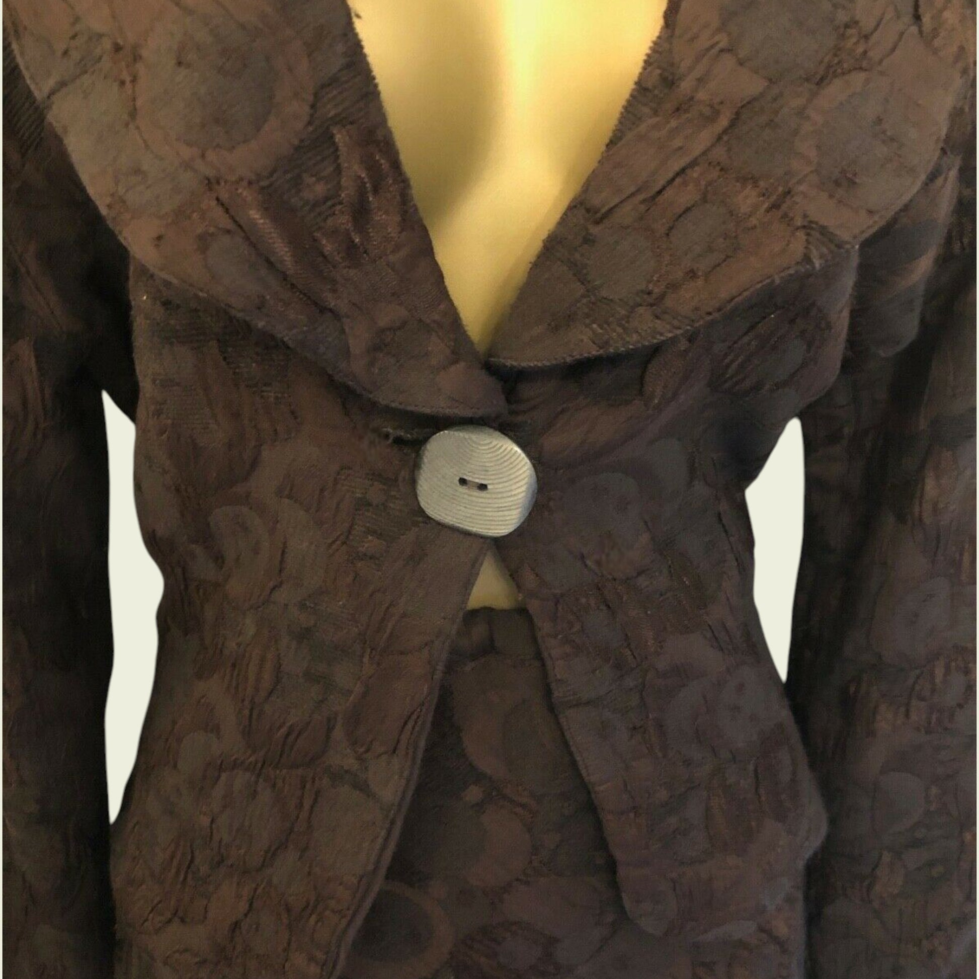Brown textured coat on a mannequin with a plain background