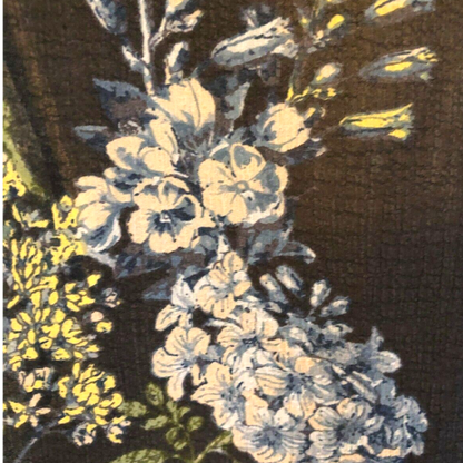 Close-up of a floral pattern with white and yellow flowers on a dark background
