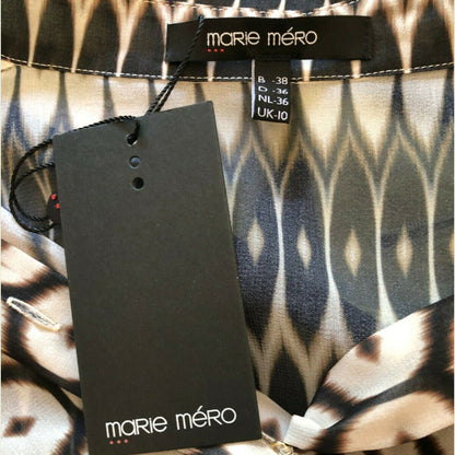 Marie Méro clothing tag on a patterned fabric background