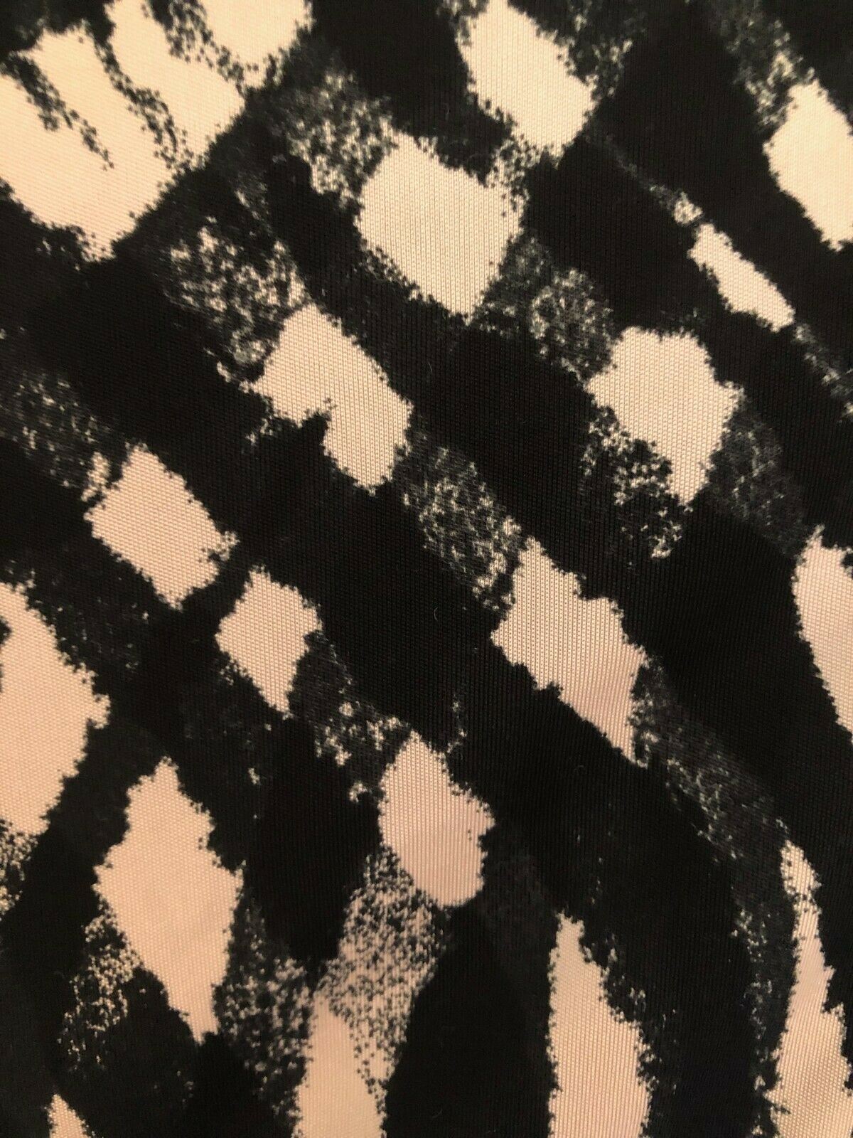 Close-up of fabric with black and beige abstract pattern